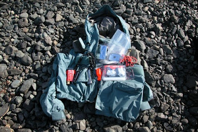 When we are in the plane or walking around we have our coats on which contain our basic survival equipment. If we get lost in the wood or leave the burning plane we have basic equipment ready to go. The coats we use are Patagonia water proof fishing jackets. I have been looking for a good coat with a built in life jacket. Both our coats have the same equipment.