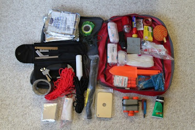 Miscellaneous gear most of which you can see. If you do not die in the crash the big reason for death is hypothermia. Keeping a fire going through the night is not easy, carry a good saw. Foil squares in upper left are survival food. Small gray on right side is a survival stove.