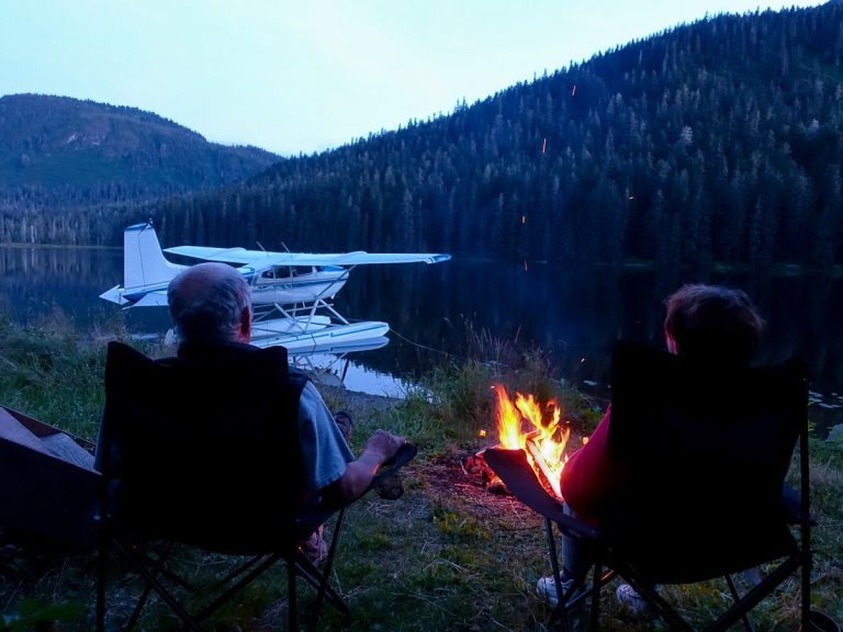 Couple Enjoying a Fire in Front of their Cessna 180